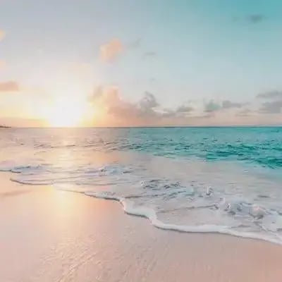 Wave on a beach at sunset