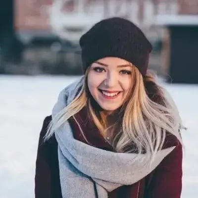 Portrait of a smiling woman in a beanie and scarf